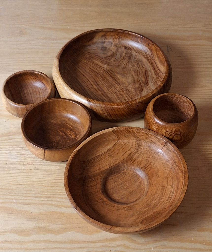 These beautifully crafted wooden bowls, with their natural grain patterns and smooth finishes, evoke a sense of tranquility and connection to nature, promoting a feeling of well-being in any space.